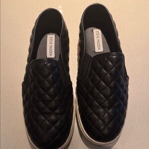 Black quilted leather slip-ons